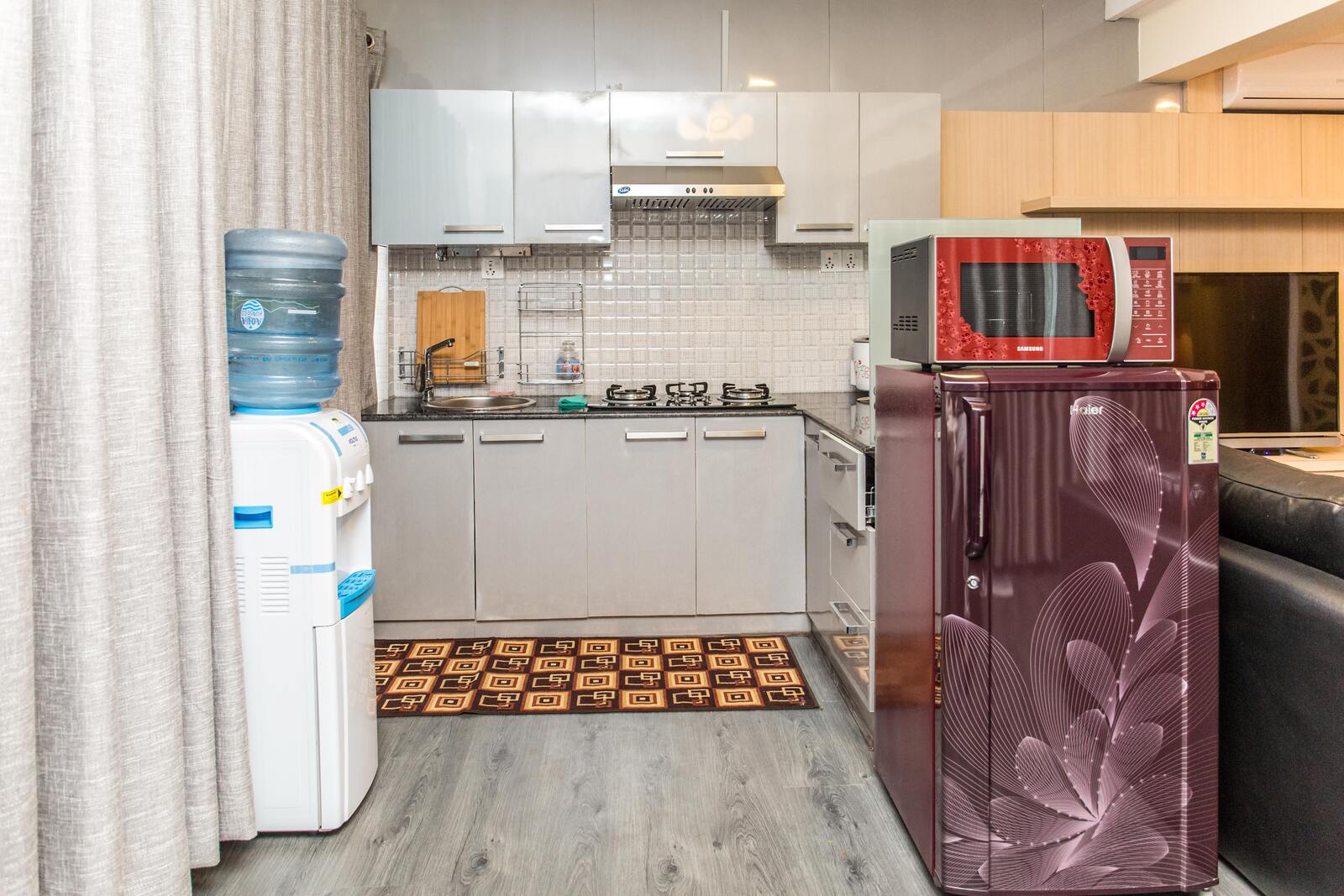 The kitchen, with fridge, gas hob, microwave and drinking-water dispenser.