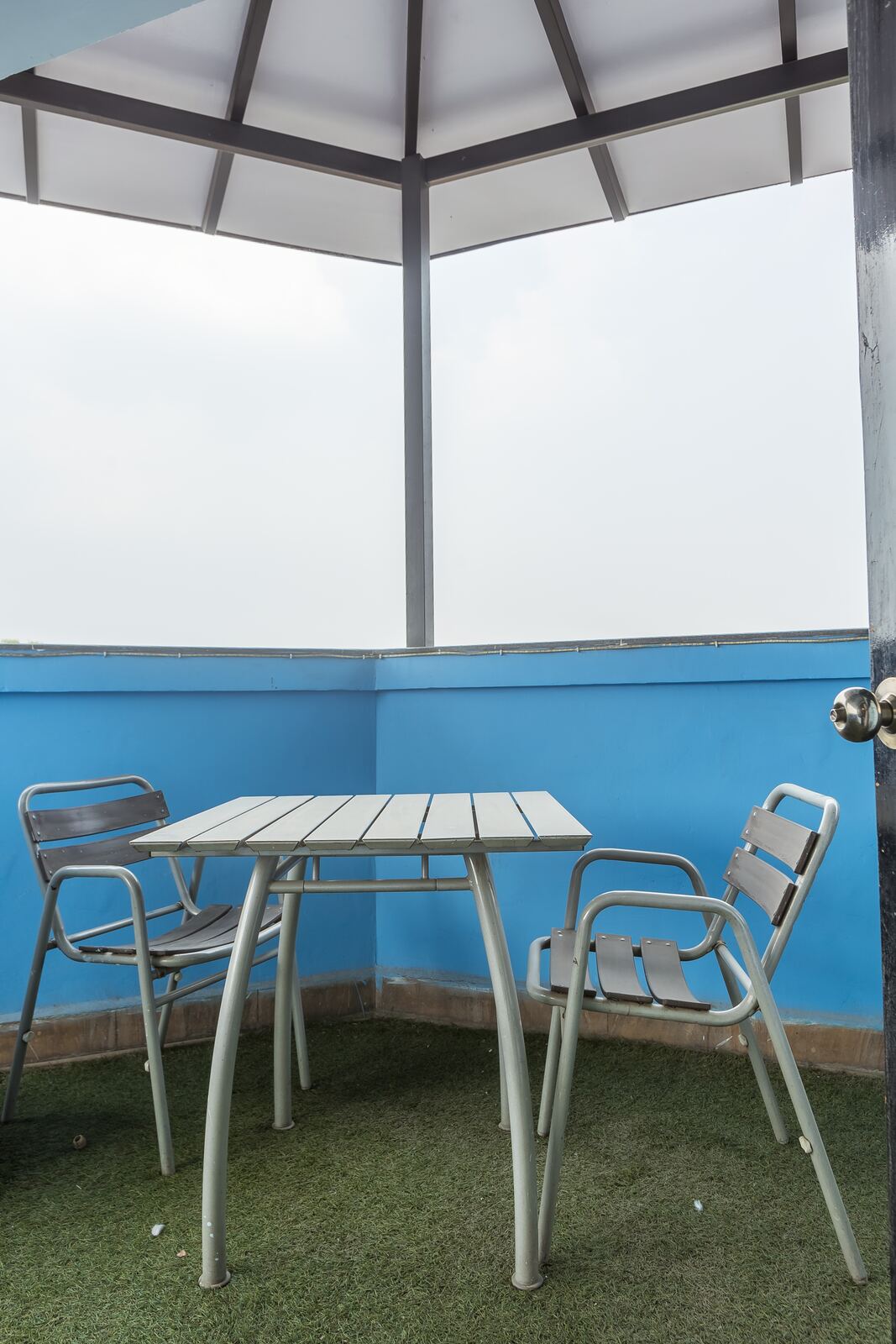 The balcony, with a table and chairs.